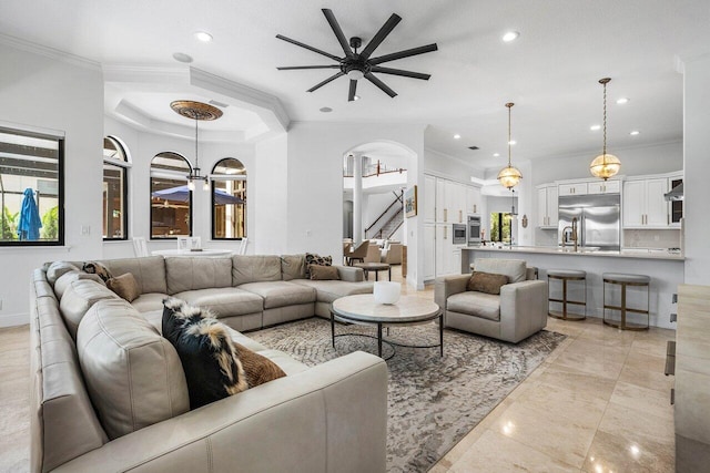 8984 Three Rail Dr, Boynton Beach, FL 33472 - living area with ceiling fan, ornamental molding, recessed lighting, stairs, and arched walkways