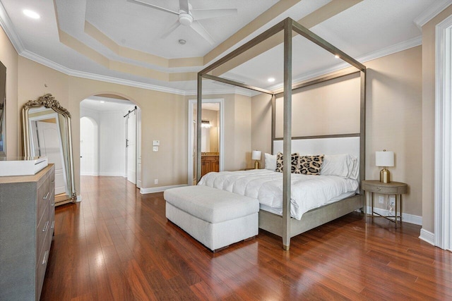 8984 Three Rail Dr, Boynton Beach, FL 33472 - bedroom with arched walkways, dark wood finished floors, crown molding, a raised ceiling, and recessed lighting
