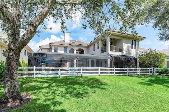 8984 Three Rail Dr, Boynton Beach, FL 33472 - rear view of house featuring a balcony, stucco siding, a fenced backyard, and a chimney