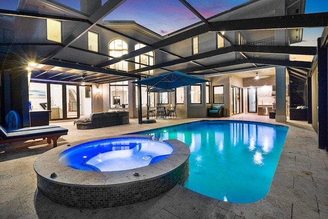8984 Three Rail Dr, Boynton Beach, FL 33472 - pool at dusk with a patio, a lanai, a pool with connected hot tub, a ceiling fan, and outdoor dining space