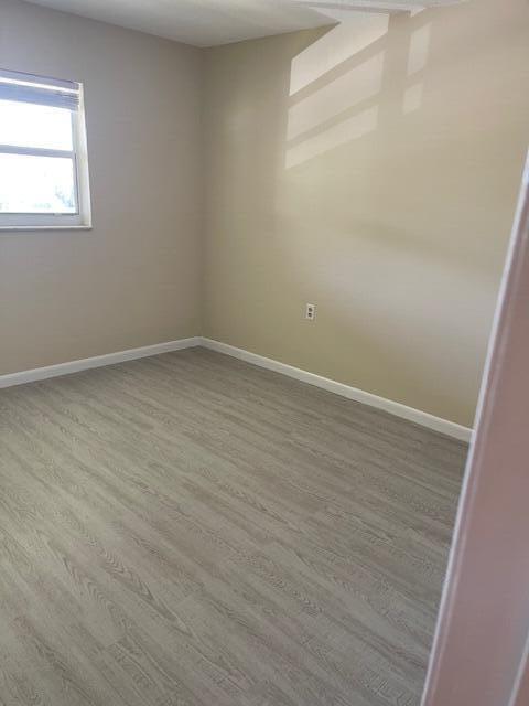 1900 S Kanner Hwy Unit 5-206, Stuart, FL 34994 - spare room with wood finished floors and baseboards