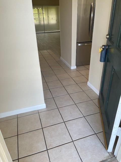 1900 S Kanner Hwy Unit 5-206, Stuart, FL 34994 - hall featuring light tile patterned flooring and baseboards