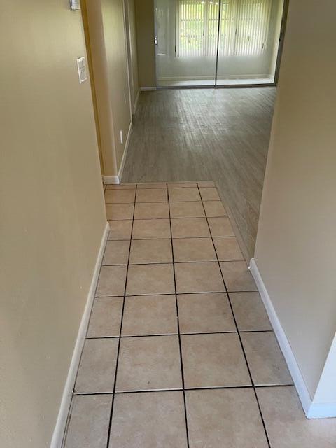1900 S Kanner Hwy Unit 5-206, Stuart, FL 34994 - corridor featuring baseboards and light tile patterned flooring