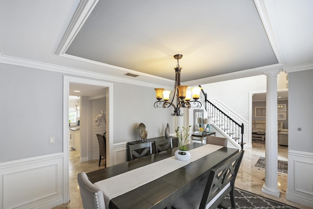 1571 SW Delos Ave, Port Saint Lucie, FL 34953 - dining area featuring a raised ceiling, a chandelier, decorative columns, a decorative wall, and ornamental molding