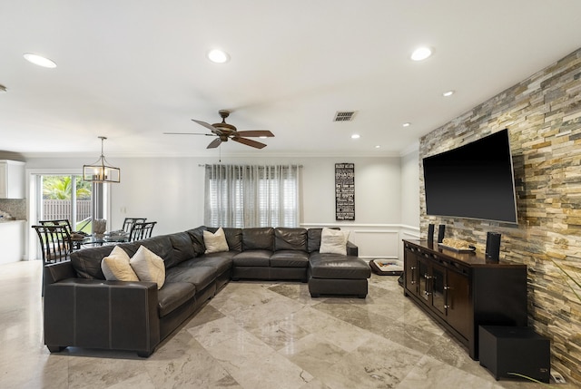 1571 SW Delos Ave, Port Saint Lucie, FL 34953 - living room featuring ceiling fan, a wainscoted wall, ornamental molding, recessed lighting, and a decorative wall