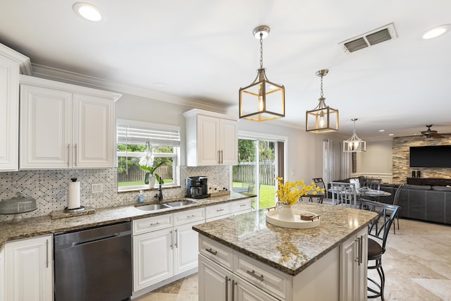 1571 SW Delos Ave, Port Saint Lucie, FL 34953 - kitchen with dishwasher, decorative backsplash, open floor plan, light stone counters, and recessed lighting