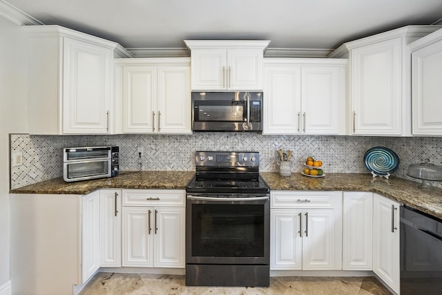 1571 SW Delos Ave, Port Saint Lucie, FL 34953 - kitchen featuring appliances with stainless steel finishes, white cabinetry, dark stone counters, and ornamental molding