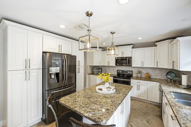 1571 SW Delos Ave, Port Saint Lucie, FL 34953 - kitchen featuring stainless steel appliances, white cabinets, decorative backsplash, a center island, and recessed lighting