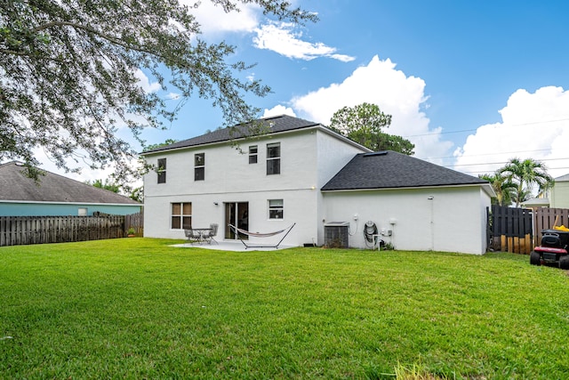 1571 SW Delos Ave, Port Saint Lucie, FL 34953 - rear view of house featuring a fenced backyard, a shingled roof, a patio, and stucco siding