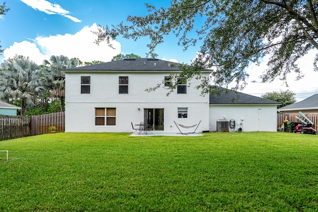 1571 SW Delos Ave, Port Saint Lucie, FL 34953 - back of house with a fenced backyard, stucco siding, and a patio