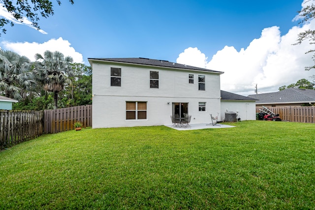 1571 SW Delos Ave, Port Saint Lucie, FL 34953 - back of property featuring stucco siding, a fenced backyard, and a patio area