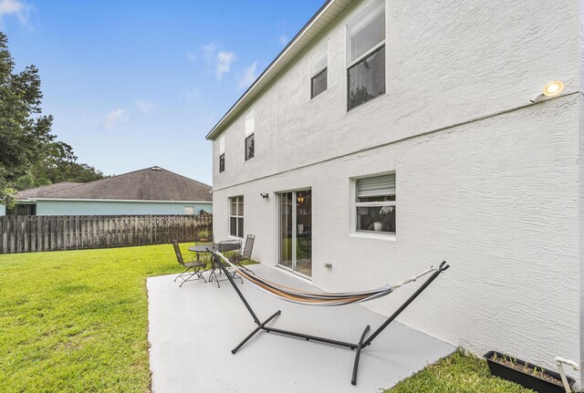 1571 SW Delos Ave, Port Saint Lucie, FL 34953 - rear view of house featuring a patio area and stucco siding