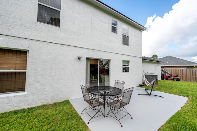 1571 SW Delos Ave, Port Saint Lucie, FL 34953 - rear view of house featuring stucco siding, a patio, and outdoor dining area