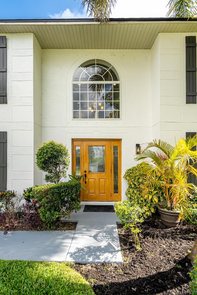 1571 SW Delos Ave, Port Saint Lucie, FL 34953 - view of exterior entry featuring stucco siding