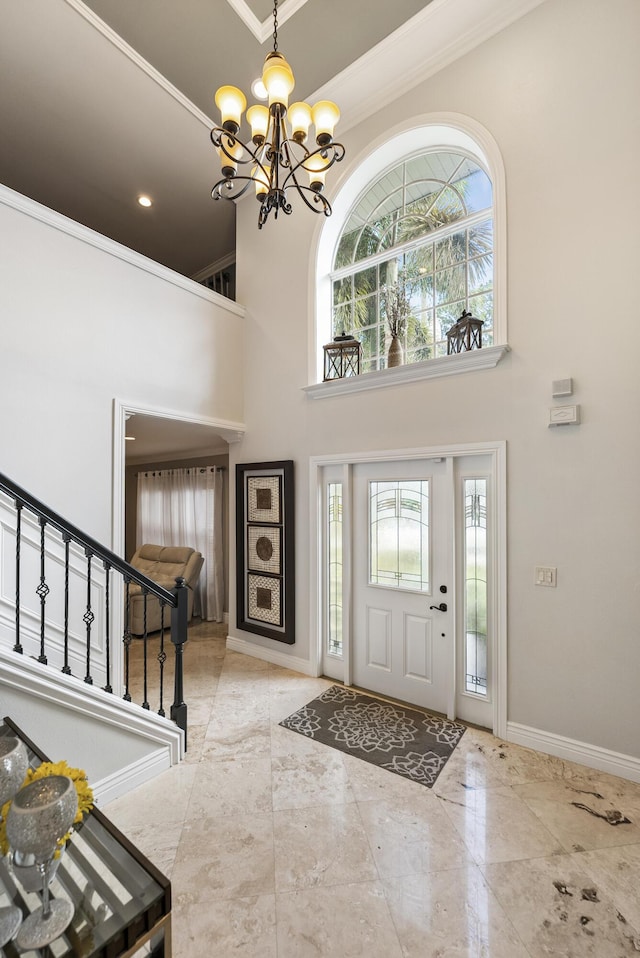 1571 SW Delos Ave, Port Saint Lucie, FL 34953 - foyer entrance with a towering ceiling, plenty of natural light, ornamental molding, a chandelier, and stairway