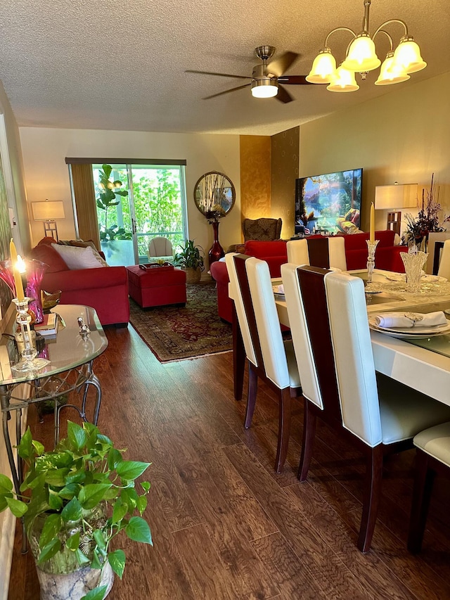 1957 SW Palm City Rd Unit B, Stuart, FL 34994 - dining area with wood finished floors, a textured ceiling, a chandelier, and a ceiling fan