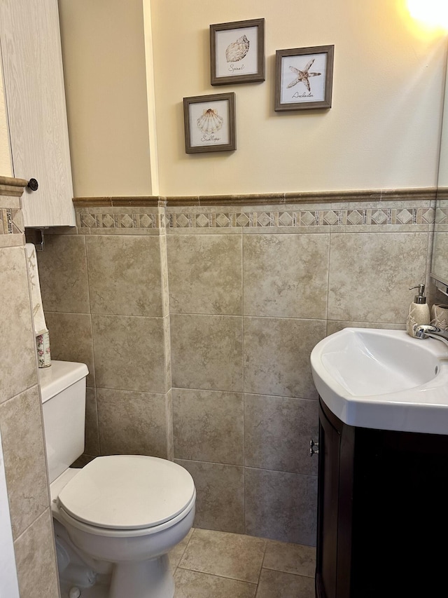1957 SW Palm City Rd Unit B, Stuart, FL 34994 - bathroom with tile walls, vanity, a wainscoted wall, and tile patterned flooring