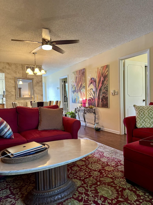 1957 SW Palm City Rd Unit B, Stuart, FL 34994 - living room featuring a textured ceiling, a chandelier, wood finished floors, and a ceiling fan