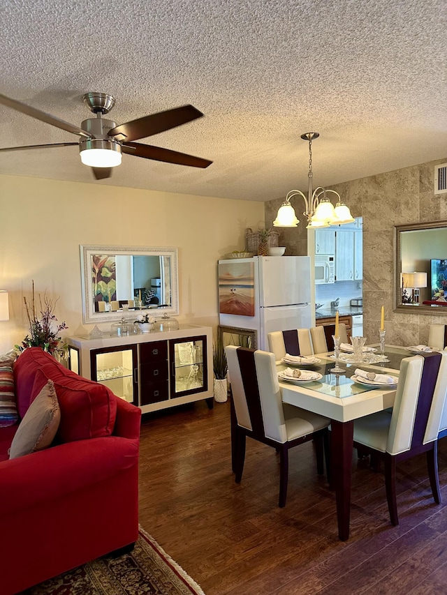 1957 SW Palm City Rd Unit B, Stuart, FL 34994 - dining room with wood finished floors, a textured ceiling, a chandelier, and ceiling fan