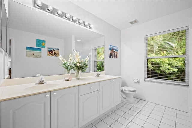 1047 Via Jardin, Riviera Beach, FL 33418 - bathroom with double vanity, tile patterned floors, and a textured ceiling