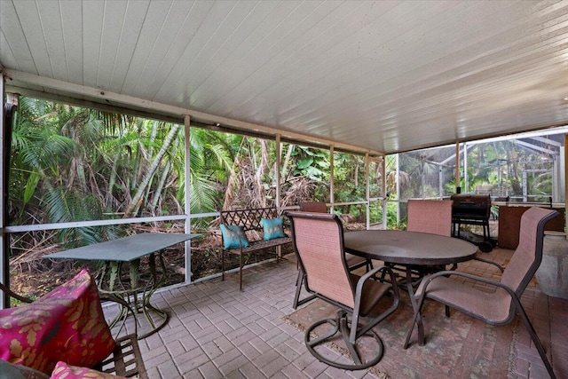 1047 Via Jardin, Riviera Beach, FL 33418 - sunroom / solarium featuring outdoor dining area