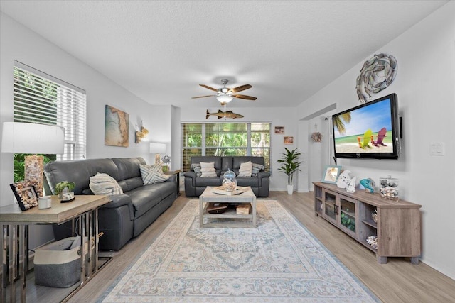 1047 Via Jardin, Riviera Beach, FL 33418 - living area featuring light wood-style floors, ceiling fan, and a textured ceiling