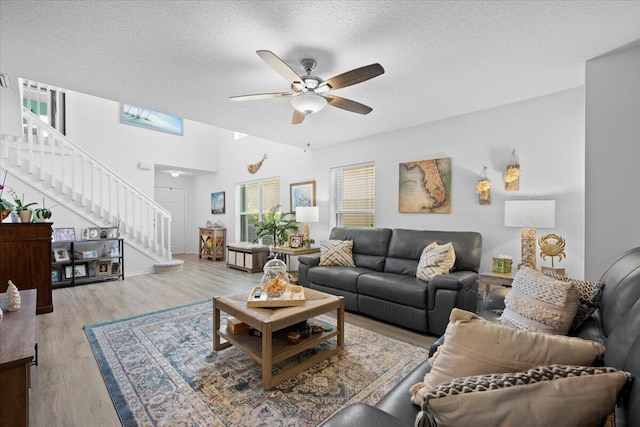 1047 Via Jardin, Riviera Beach, FL 33418 - living room with stairs, ceiling fan, a textured ceiling, and wood finished floors