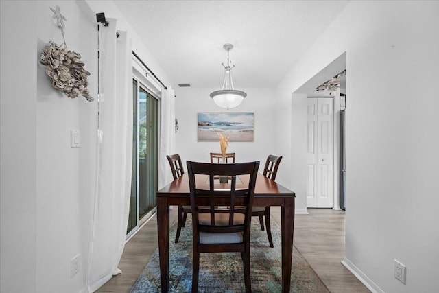1047 Via Jardin, Riviera Beach, FL 33418 - dining room featuring wood finished floors and baseboards