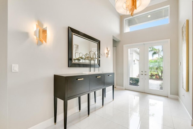 10948 SW Ivory Springs Ln, Port Saint Lucie, FL 34987 - entrance foyer featuring french doors, a high ceiling, and light tile patterned flooring