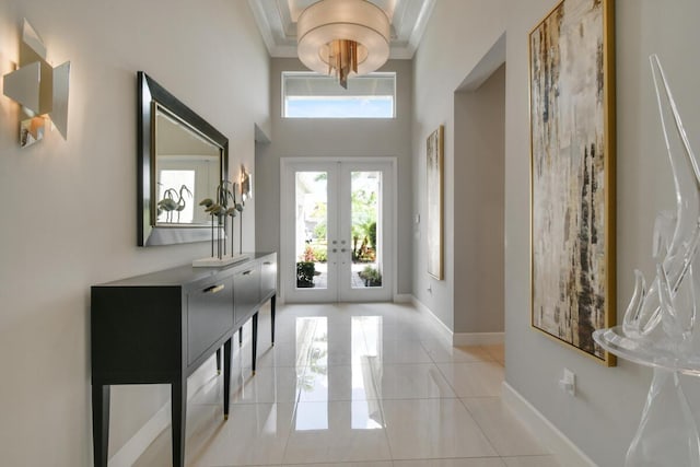 10948 SW Ivory Springs Ln, Port Saint Lucie, FL 34987 - foyer with french doors, a towering ceiling, tile patterned flooring, and crown molding