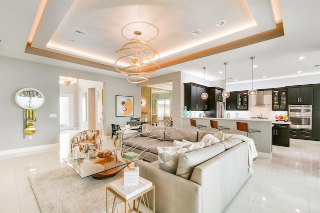 10948 SW Ivory Springs Ln, Port Saint Lucie, FL 34987 - living room featuring light tile patterned floors, a tray ceiling, a chandelier, and recessed lighting