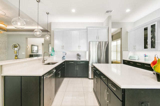 10948 SW Ivory Springs Ln, Port Saint Lucie, FL 34987 - kitchen featuring appliances with stainless steel finishes, light countertops, white cabinets, and recessed lighting