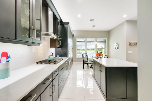 10948 SW Ivory Springs Ln, Port Saint Lucie, FL 34987 - kitchen featuring appliances with stainless steel finishes, light countertops, light tile patterned floors, glass insert cabinets, and recessed lighting