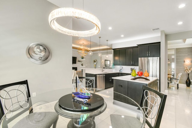 10948 SW Ivory Springs Ln, Port Saint Lucie, FL 34987 - kitchen featuring light countertops, a center island, stainless steel appliances, light tile patterned flooring, and recessed lighting