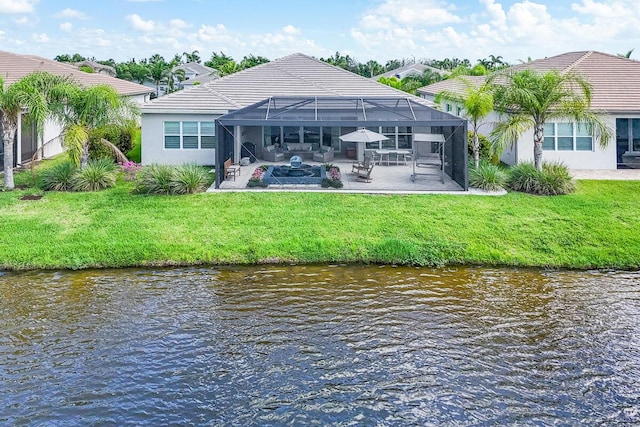 10948 SW Ivory Springs Ln, Port Saint Lucie, FL 34987 - rear view of property featuring a patio area, a water view, a tile roof, and a yard