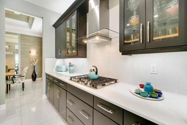 10948 SW Ivory Springs Ln, Port Saint Lucie, FL 34987 - bar featuring wall chimney exhaust hood, stainless steel gas stovetop, and light tile patterned flooring