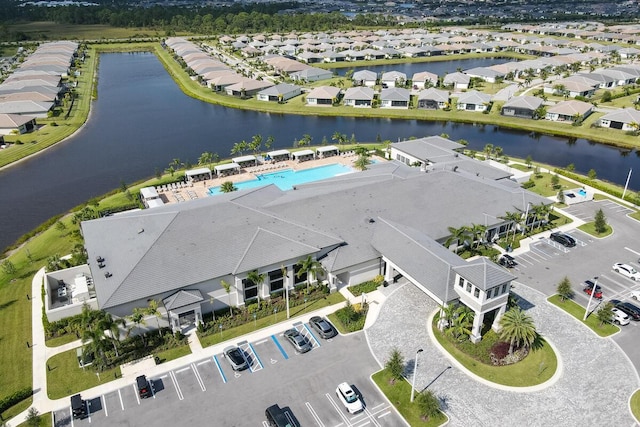 10948 SW Ivory Springs Ln, Port Saint Lucie, FL 34987 - aerial view of residential area with a nearby body of water and a pool area