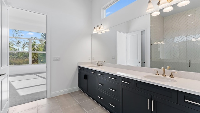 2165 SE Mosaic Blvd, Port Saint Lucie, FL 34984 - bathroom with healthy amount of natural light, double vanity, tile patterned floors, and a shower stall