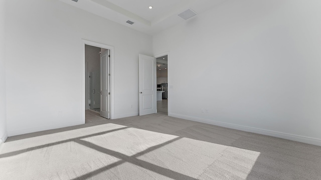 2165 SE Mosaic Blvd, Port Saint Lucie, FL 34984 - unfurnished bedroom featuring light colored carpet, recessed lighting, ensuite bathroom, and a high ceiling