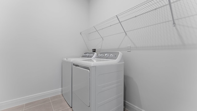 2165 SE Mosaic Blvd, Port Saint Lucie, FL 34984 - washroom with independent washer and dryer and tile patterned floors