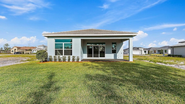2165 SE Mosaic Blvd, Port Saint Lucie, FL 34984 - rear view of property featuring a yard, stucco siding, and a residential view