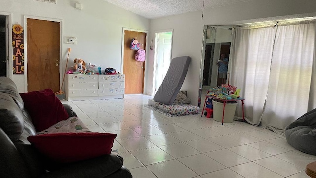 1044 SW Canary Ter, Port Saint Lucie, FL 34953 - bedroom featuring a textured ceiling and tile patterned flooring