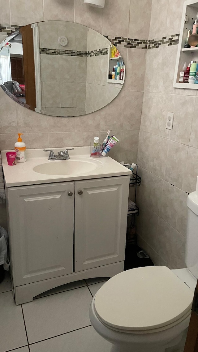 1044 SW Canary Ter, Port Saint Lucie, FL 34953 - half bathroom with tile walls, vanity, and tile patterned floors