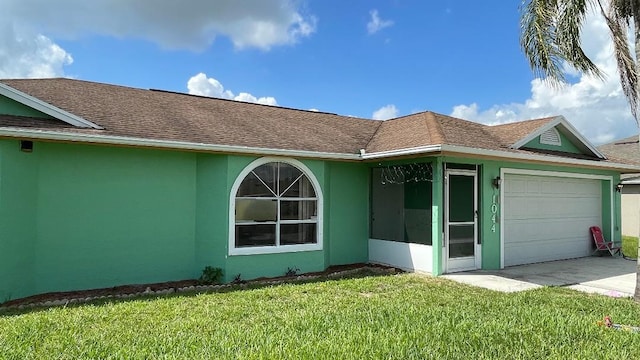 1044 SW Canary Ter, Port Saint Lucie, FL 34953 - view of front facade featuring an attached garage, a front yard, roof with shingles, and stucco siding
