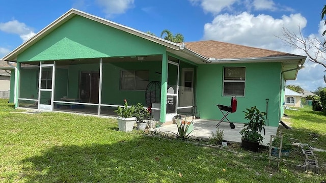 1044 SW Canary Ter, Port Saint Lucie, FL 34953 - rear view of property featuring a sunroom, a yard, a patio area, and a shingled roof