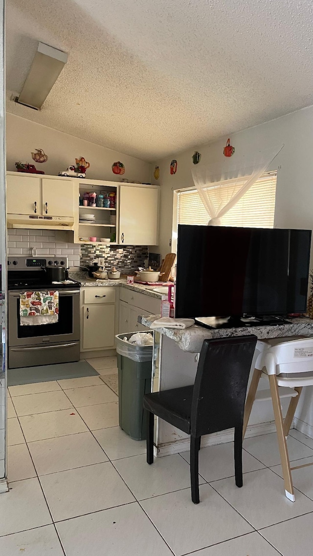 1044 SW Canary Ter, Port Saint Lucie, FL 34953 - kitchen featuring stainless steel range with electric stovetop, a textured ceiling, backsplash, open shelves, and under cabinet range hood