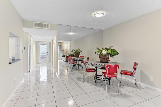 15451 Pembridge Dr Unit 207, Delray Beach, FL 33484 - dining area featuring tile patterned floors and a textured ceiling