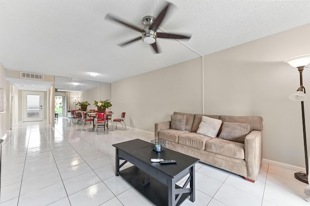 15451 Pembridge Dr Unit 207, Delray Beach, FL 33484 - living room with ceiling fan, light tile patterned floors, and a textured ceiling