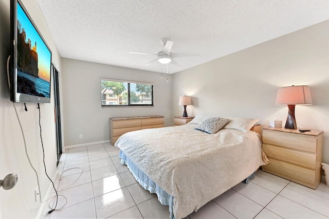 15451 Pembridge Dr Unit 207, Delray Beach, FL 33484 - bedroom with light tile patterned flooring, a textured ceiling, and a ceiling fan