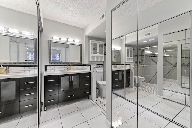 15451 Pembridge Dr Unit 207, Delray Beach, FL 33484 - full bath featuring tasteful backsplash, vanity, a stall shower, a textured ceiling, and tile patterned flooring